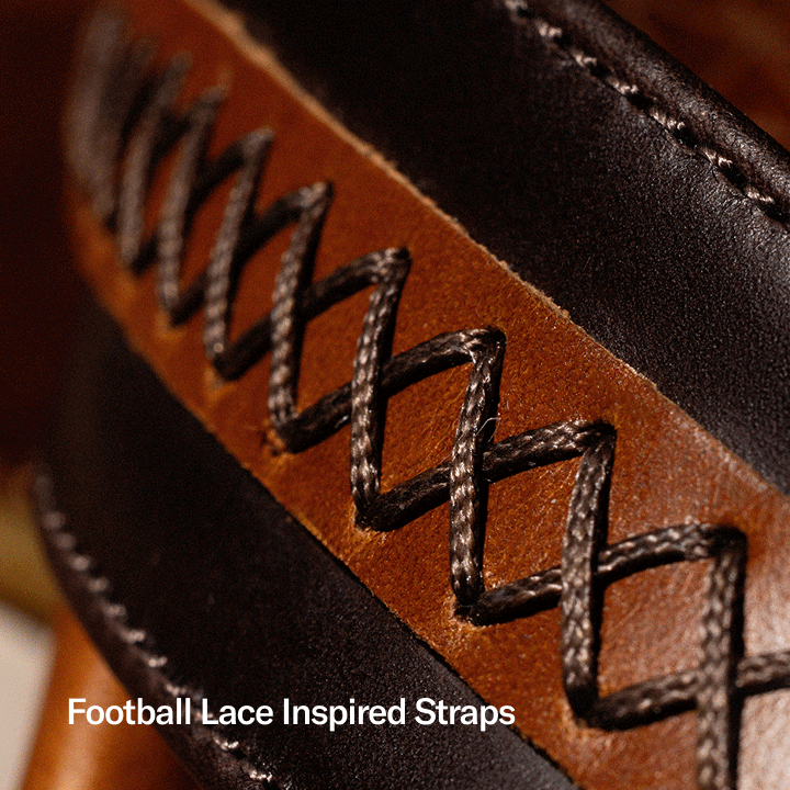 Close-up detail of premium leather sandal straps featuring football lace-inspired stitching. Black laces weave across a rich brown leather panel, highlighting craftsmanship, texture, and sport-inspired design. Overlay text reads: “Football Lace Inspired Straps.”