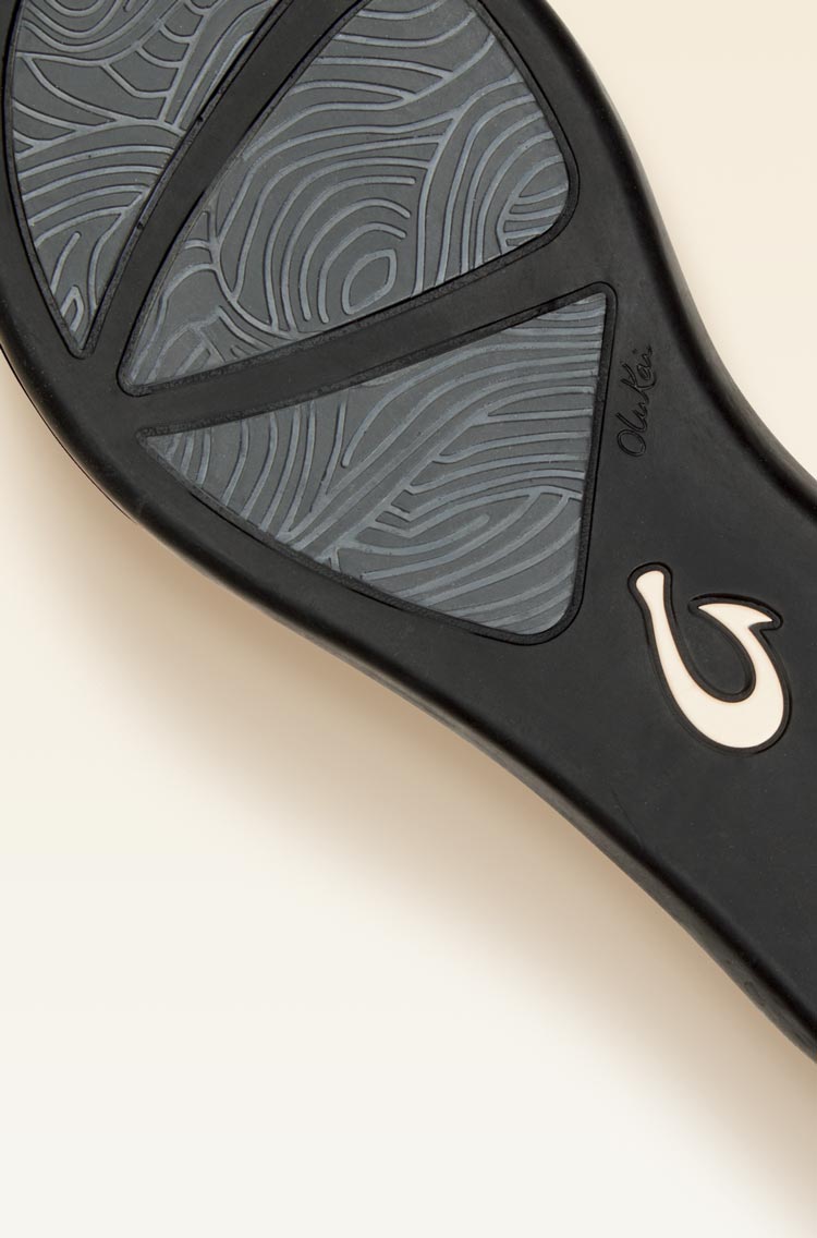 Non-marking rubber outsole with ocean current inspired traction pod design for enhanced grip and durability.